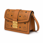Made in MCM cognac-colored Visetos canvas featuring a gold logo clasp adjustable shoulder strap and a lightweight messenger bag style suitable for both men and women