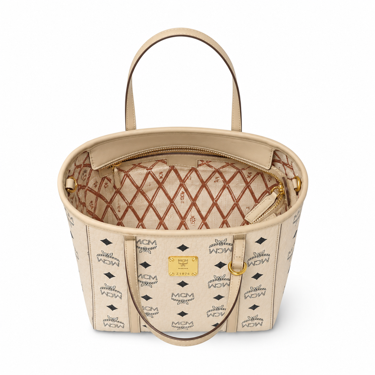 MCM off-white monogram canvas with gold nameplate, detachable shoulder strap, multi-way carrying commuter shopping bag.
