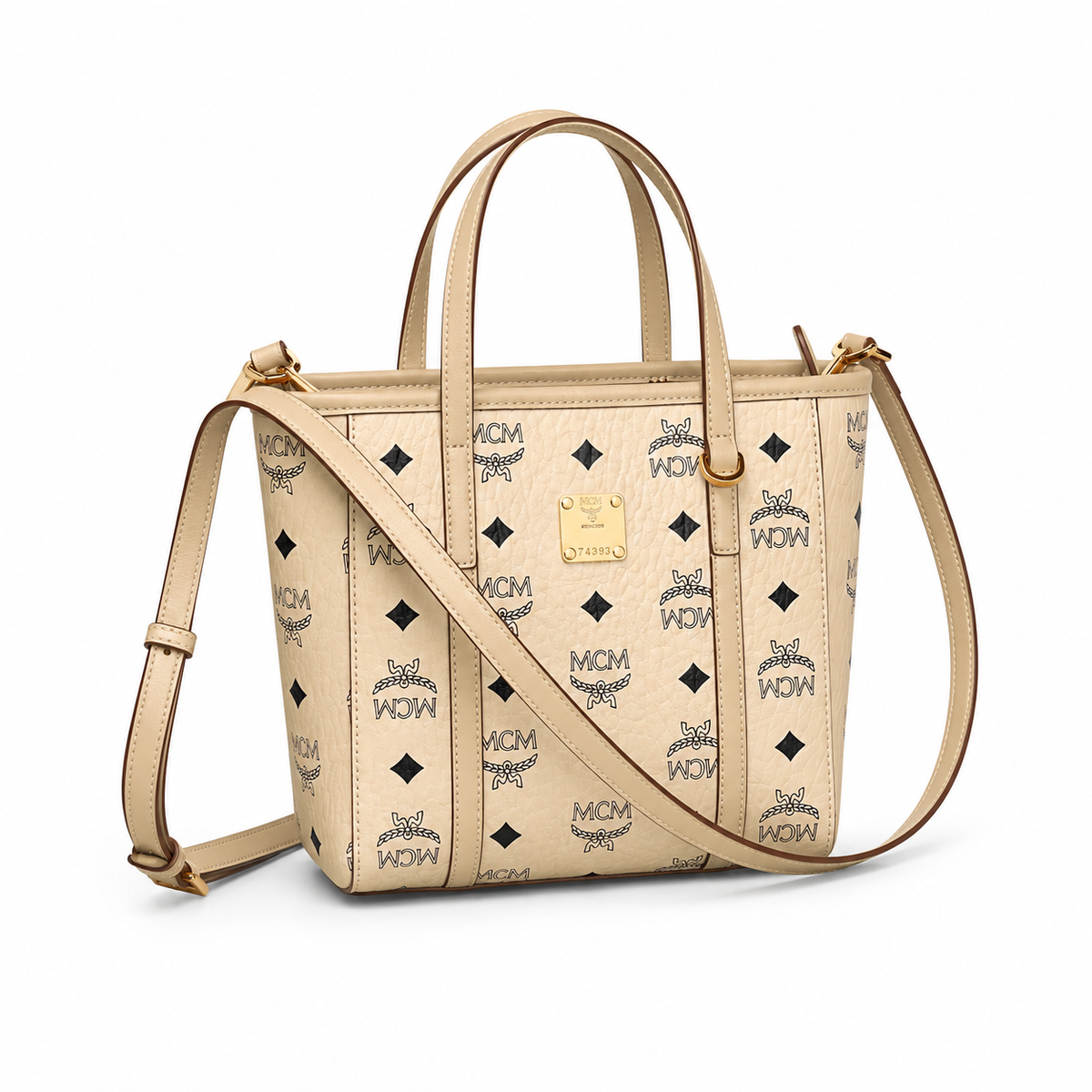 MCM off-white monogram canvas with gold nameplate, detachable shoulder strap, multi-way carrying commuter shopping bag.