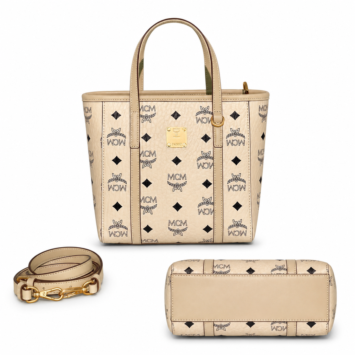 MCM off-white monogram canvas with gold nameplate, detachable shoulder strap, multi-way carrying commuter shopping bag.