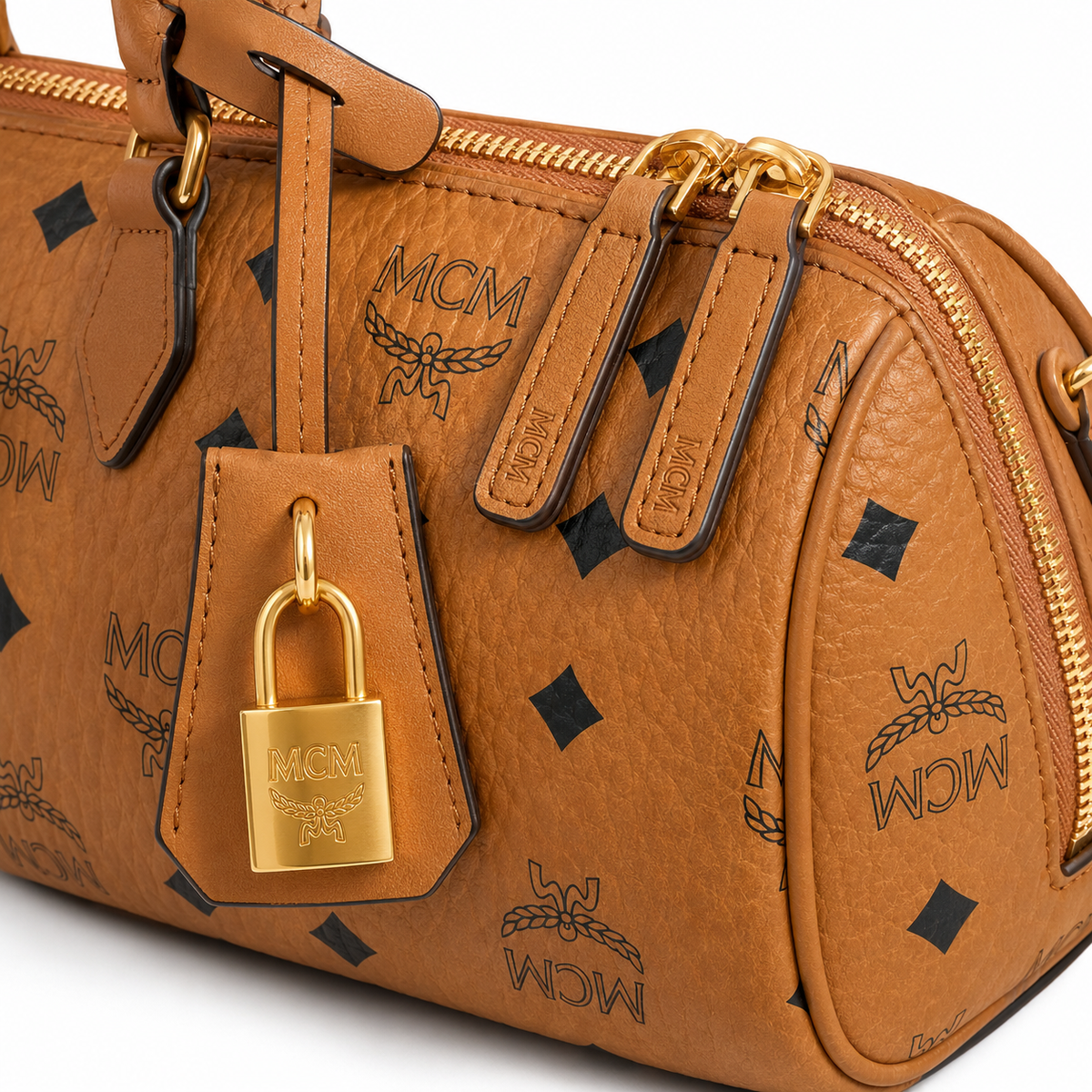MCM Cognac-colored all-over monogram canvas bag with gold padlock pendant adjustable shoulder strap handbag shoulder bag or crossbody bag