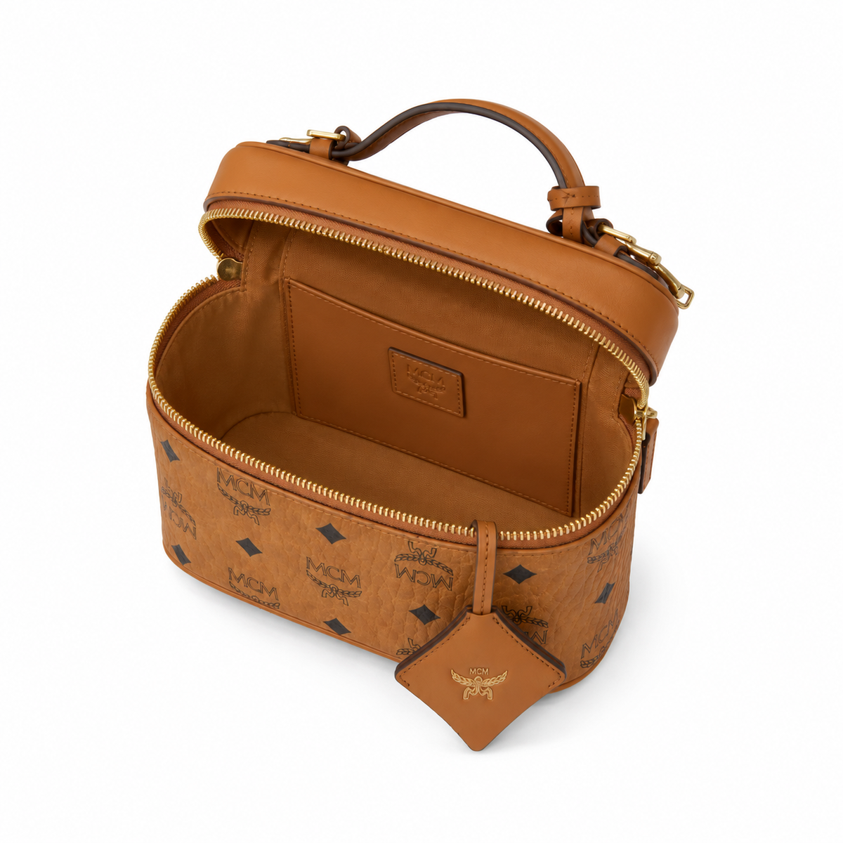 MCM Cognac-colored all-over monogram canvas bag with adjustable shoulder strap can be carried by hand over the shoulder or crossbody