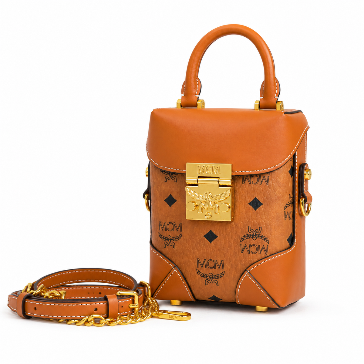 MCM cognac-colored all-over monogram canvas with a gold laurel leaf clasp Adjustable shoulder strap can be carried by hand over the shoulder or crossbody Multi-purpose women's bag