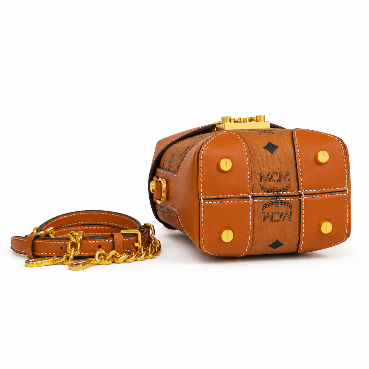 MCM cognac-colored all-over monogram canvas with a gold laurel leaf clasp Adjustable shoulder strap can be carried by hand over the shoulder or crossbody Multi-purpose women's bag