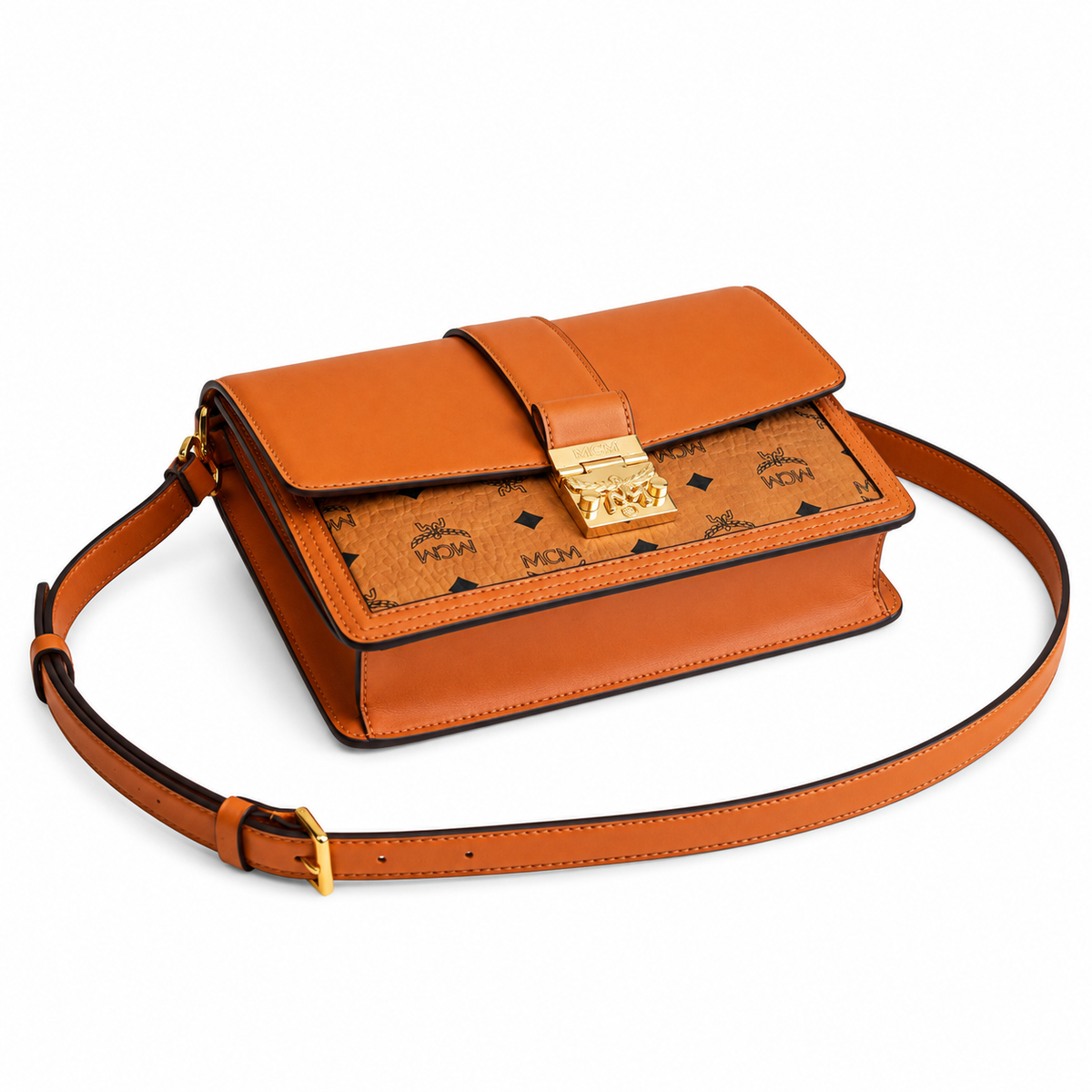 MCM monogram canvas with gold laurel leaf clasp, adjustable shoulder strap, versatile for single-shoulder or crossbody wear.