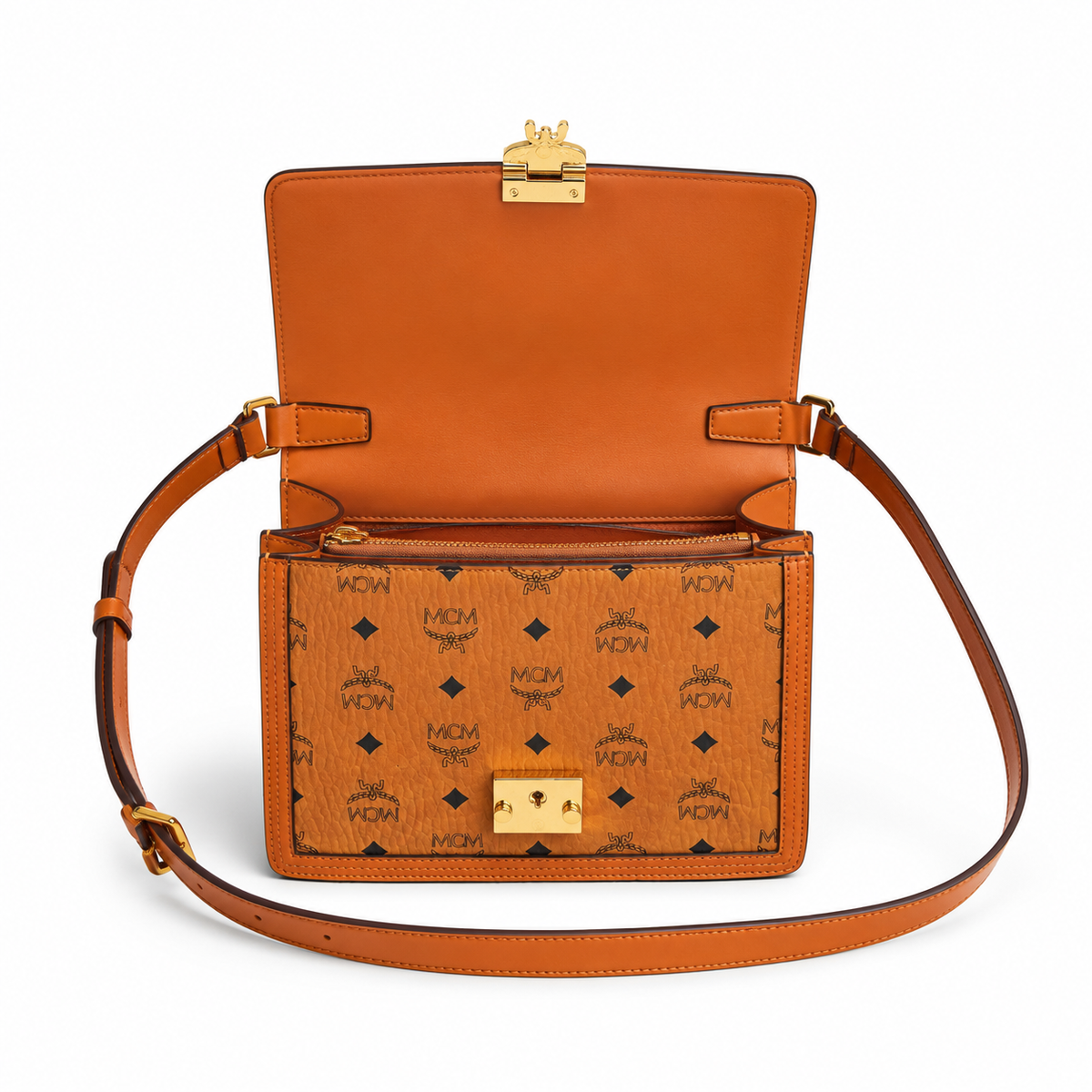 MCM monogram canvas with gold laurel leaf clasp, adjustable shoulder strap, versatile for single-shoulder or crossbody wear.