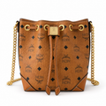 MCM Cognac-colored all-over monogram canvas bag with adjustable shoulder strap can be carried by hand over the shoulder or crossbody