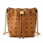 MCM Cognac-colored all-over monogram canvas bag with adjustable shoulder strap can be carried by hand over the shoulder or crossbody