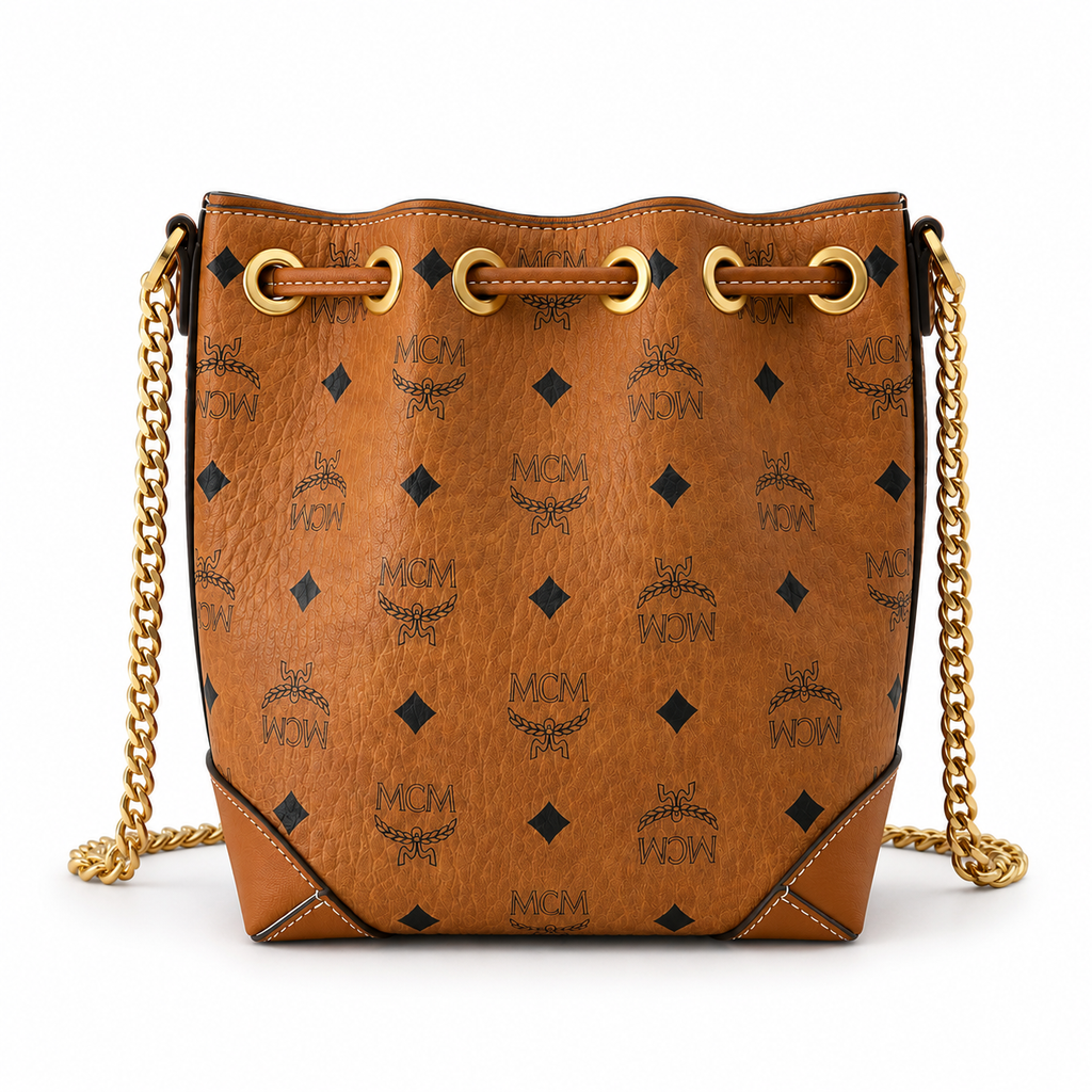 MCM Cognac-colored all-over monogram canvas bag with adjustable shoulder strap can be carried by hand over the shoulder or crossbody