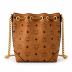 MCM Cognac-colored all-over monogram canvas bag with adjustable shoulder strap can be carried by hand over the shoulder or crossbody