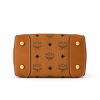 MCM Cognac-colored all-over monogram canvas bag with adjustable shoulder strap can be carried by hand over the shoulder or crossbody