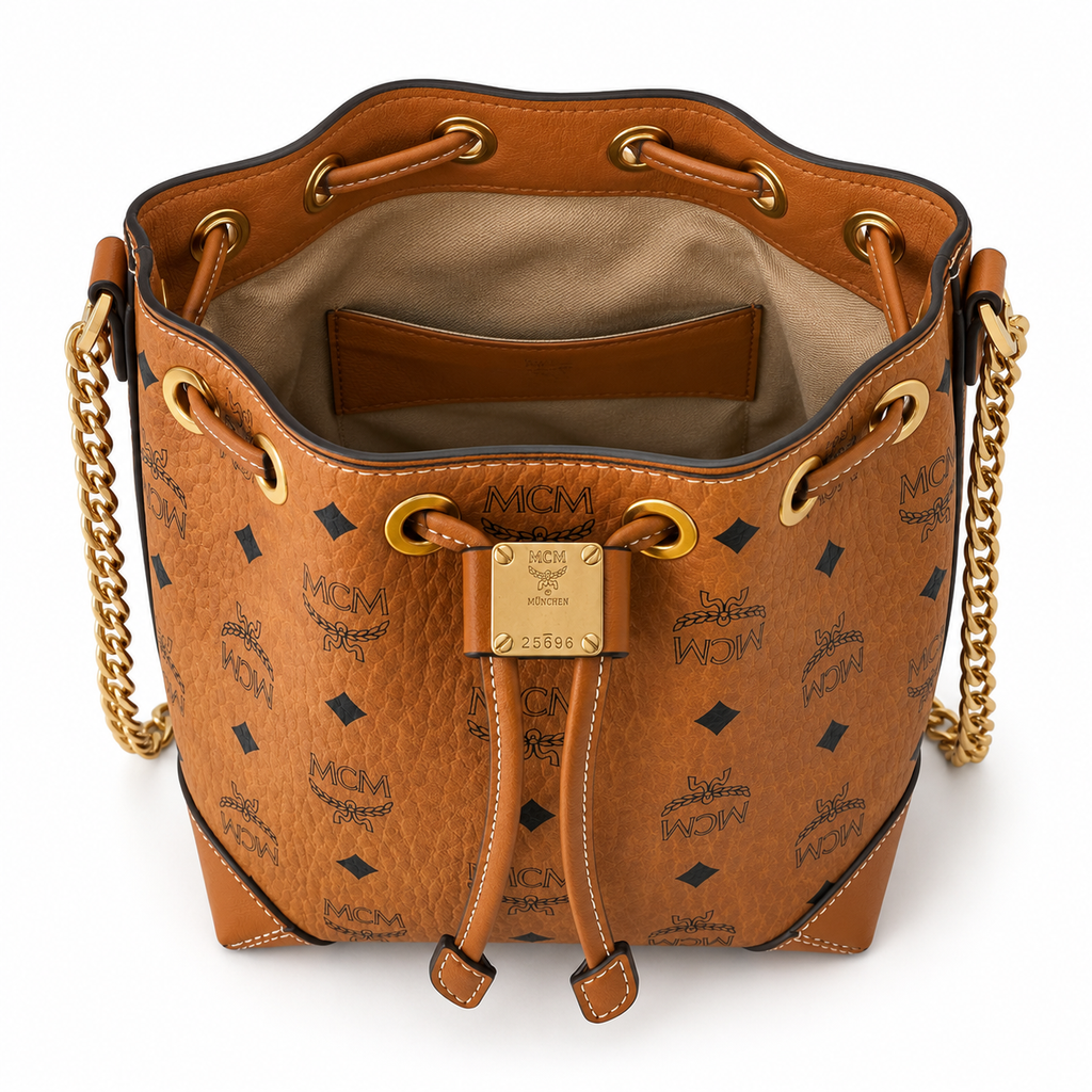 MCM Cognac-colored all-over monogram canvas bag with adjustable shoulder strap can be carried by hand over the shoulder or crossbody