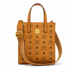 MCM cognac-colored full-width Monogram canvas with an adjustable webbing shoulder strap, suitable as a tote bag, shoulder bag, or crossbody bag.  Product Details