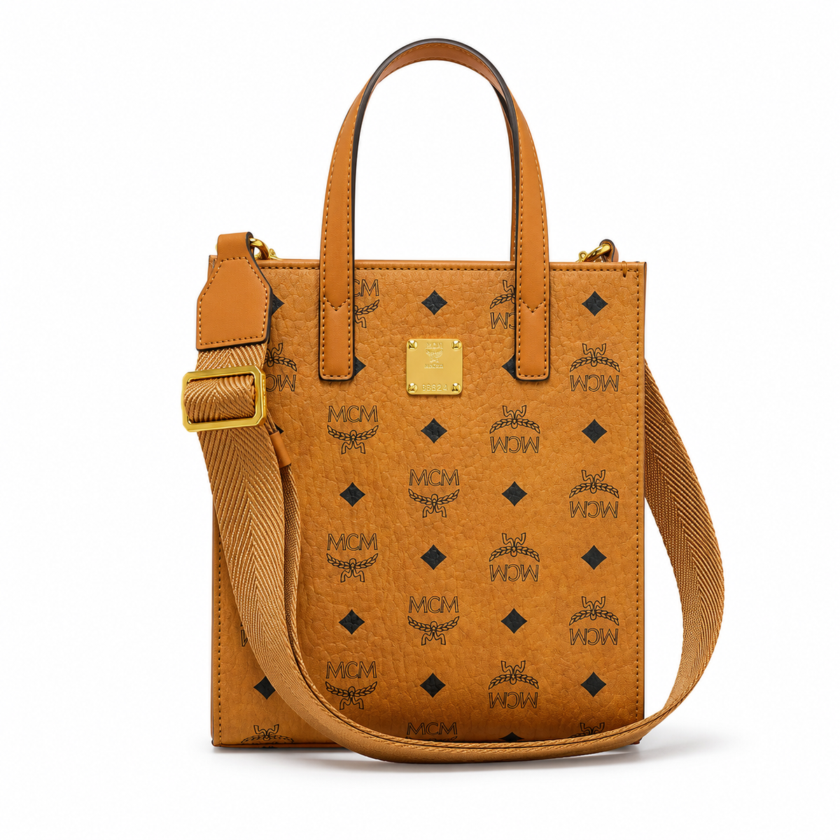 MCM cognac-colored full-width Monogram canvas with an adjustable webbing shoulder strap, suitable as a tote bag, shoulder bag, or crossbody bag.  Product Details