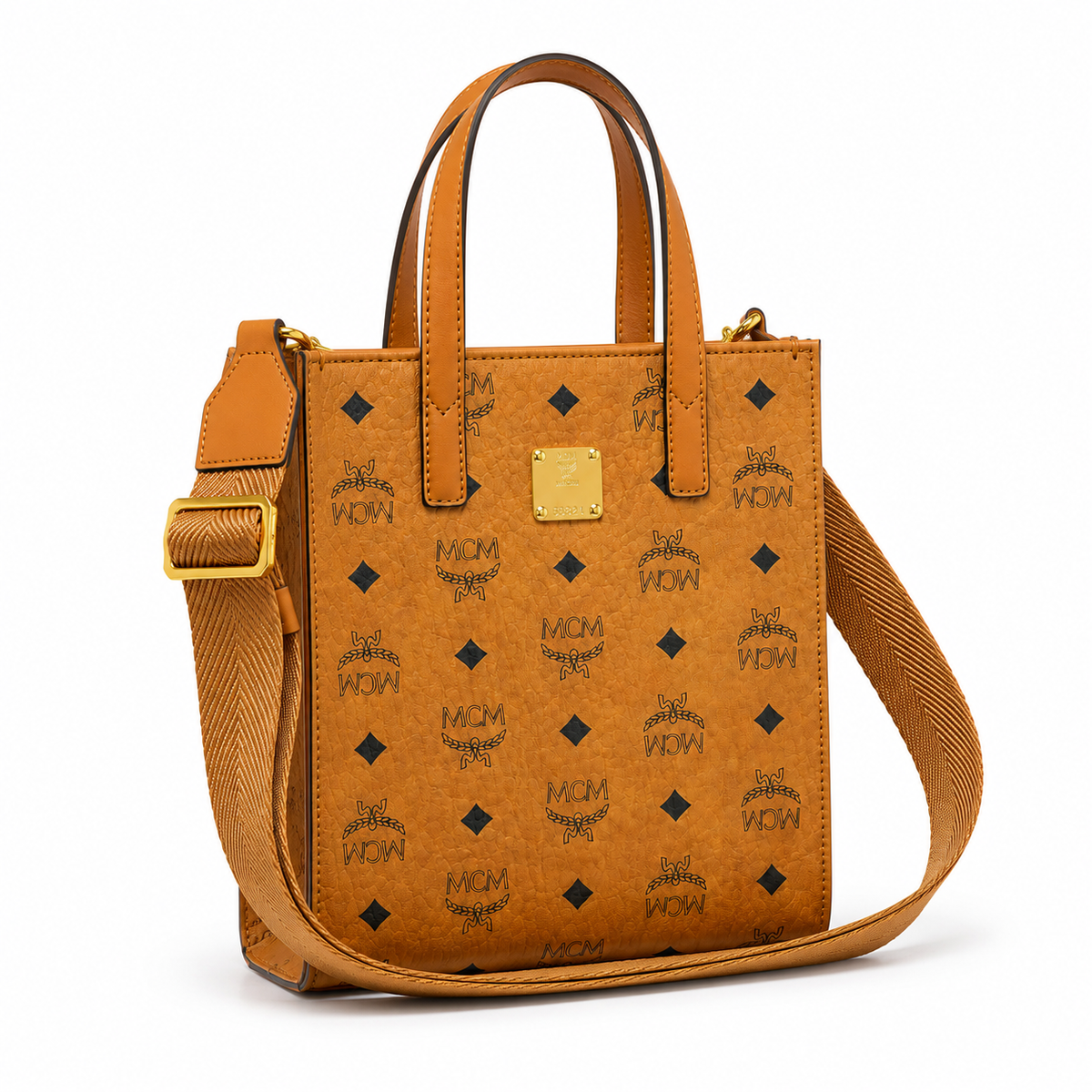 MCM cognac-colored full-width Monogram canvas with an adjustable webbing shoulder strap, suitable as a tote bag, shoulder bag, or crossbody bag.  Product Details