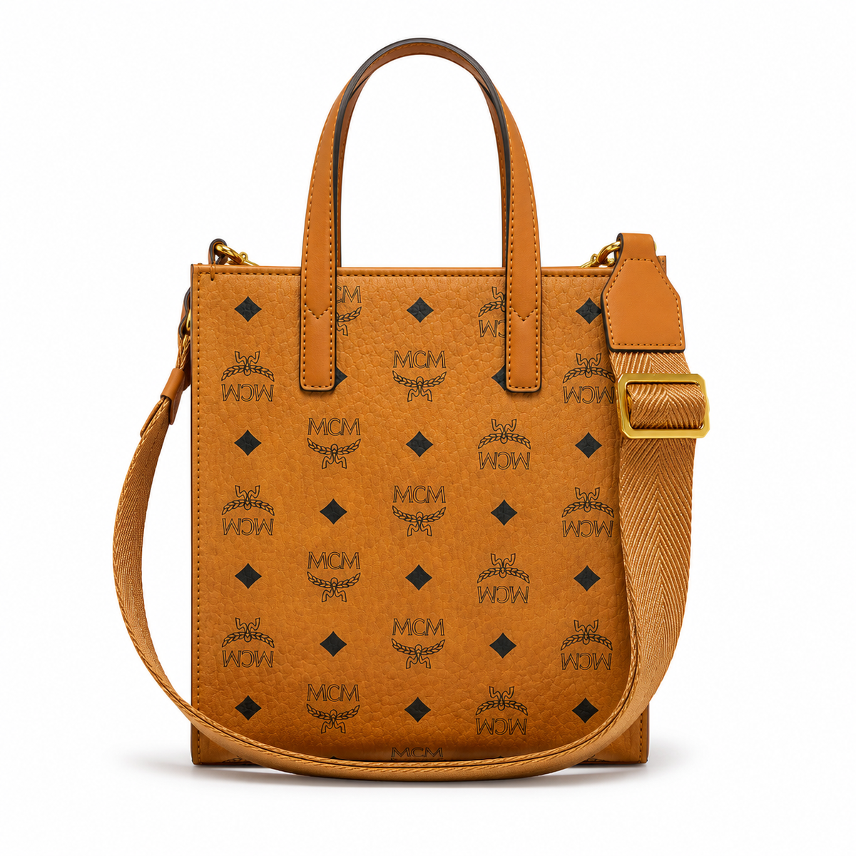 MCM cognac-colored full-width Monogram canvas with an adjustable webbing shoulder strap, suitable as a tote bag, shoulder bag, or crossbody bag.  Product Details