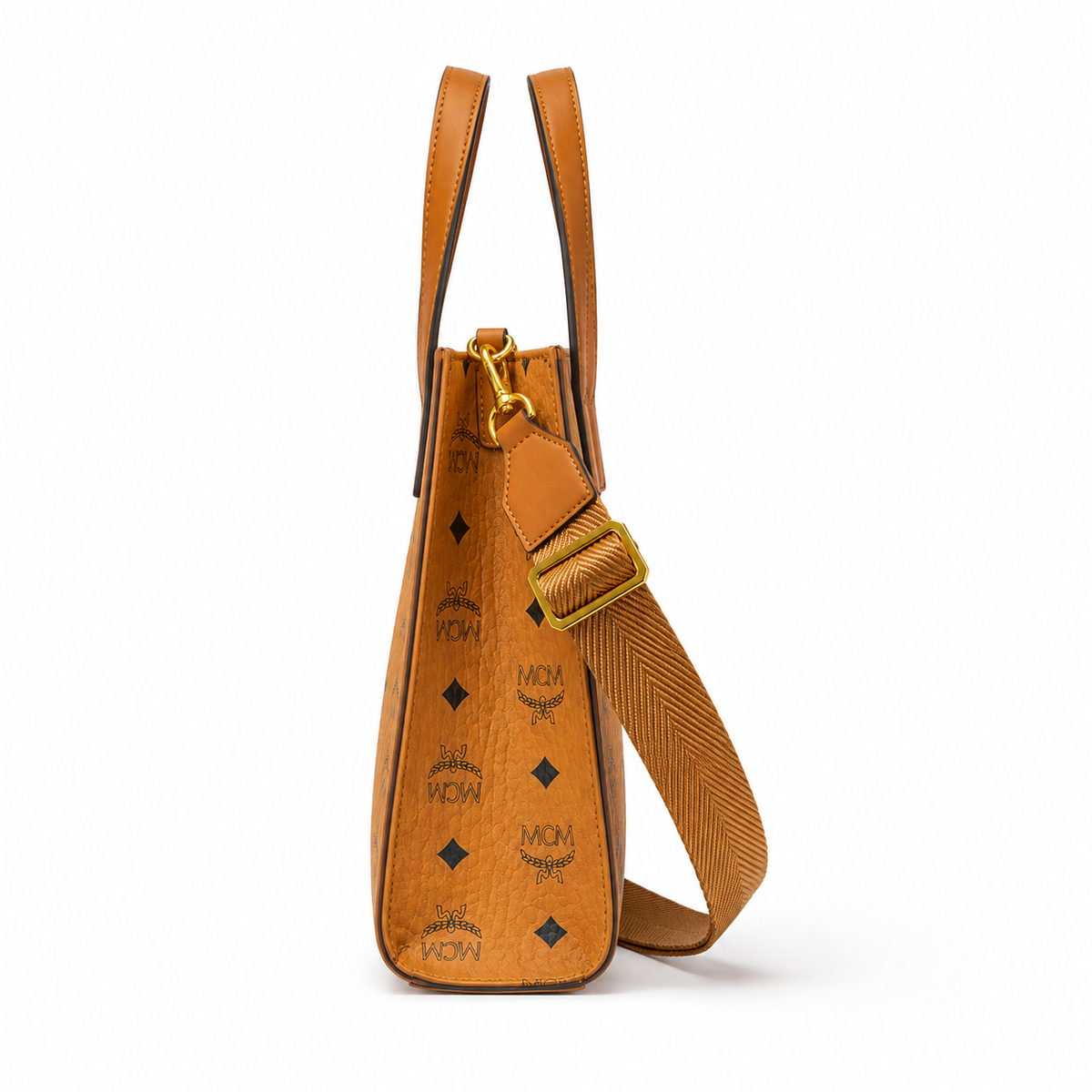 MCM cognac-colored full-width Monogram canvas with an adjustable webbing shoulder strap, suitable as a tote bag, shoulder bag, or crossbody bag.  Product Details