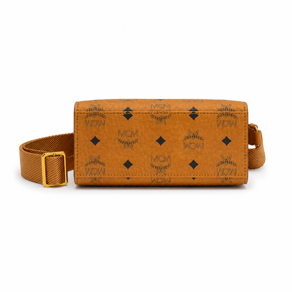 MCM cognac-colored full-width Monogram canvas with an adjustable webbing shoulder strap, suitable as a tote bag, shoulder bag, or crossbody bag.  Product Details