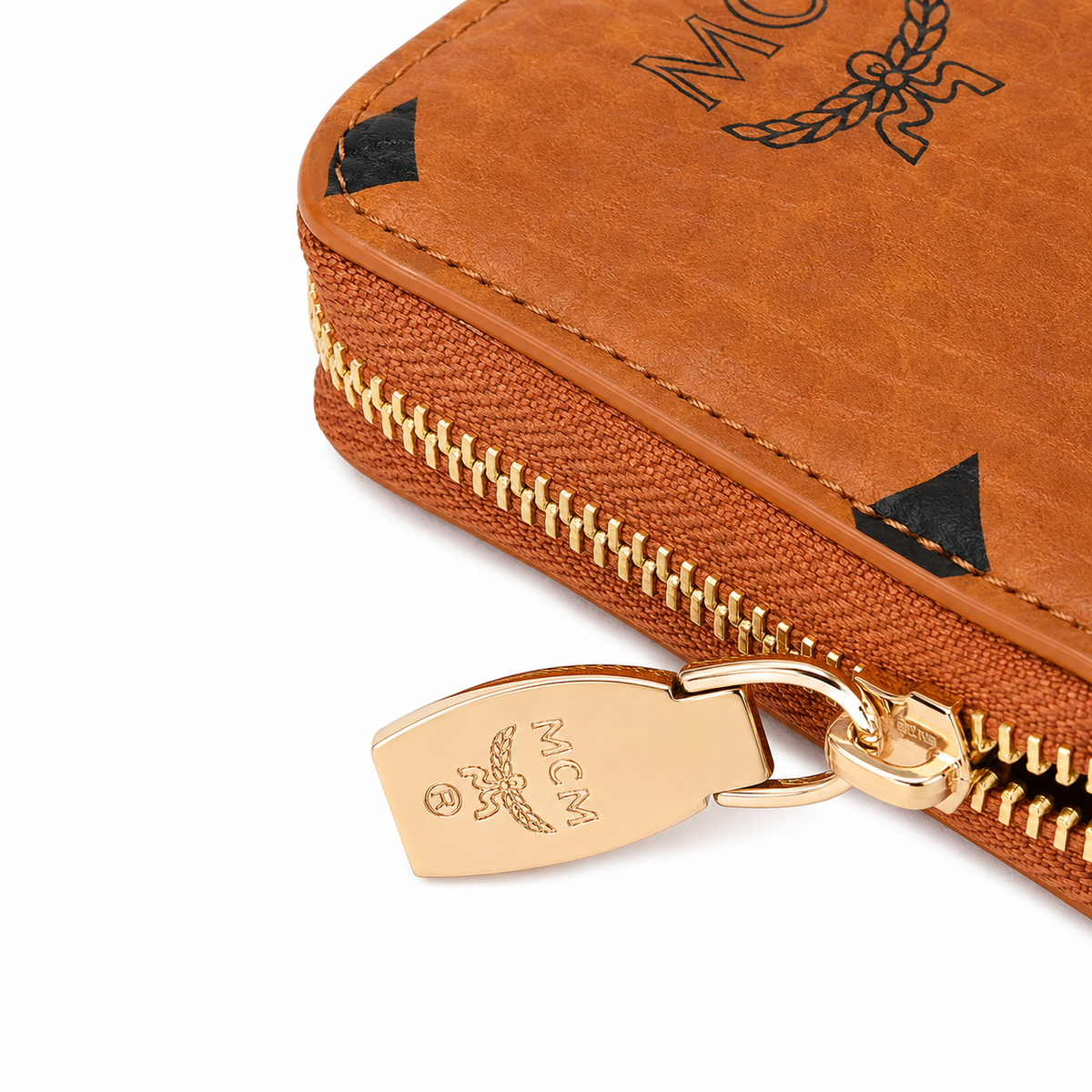 MCM women's clutch bag with all-over print in black and gold clasp featuring multiple card slots and zippered compartments