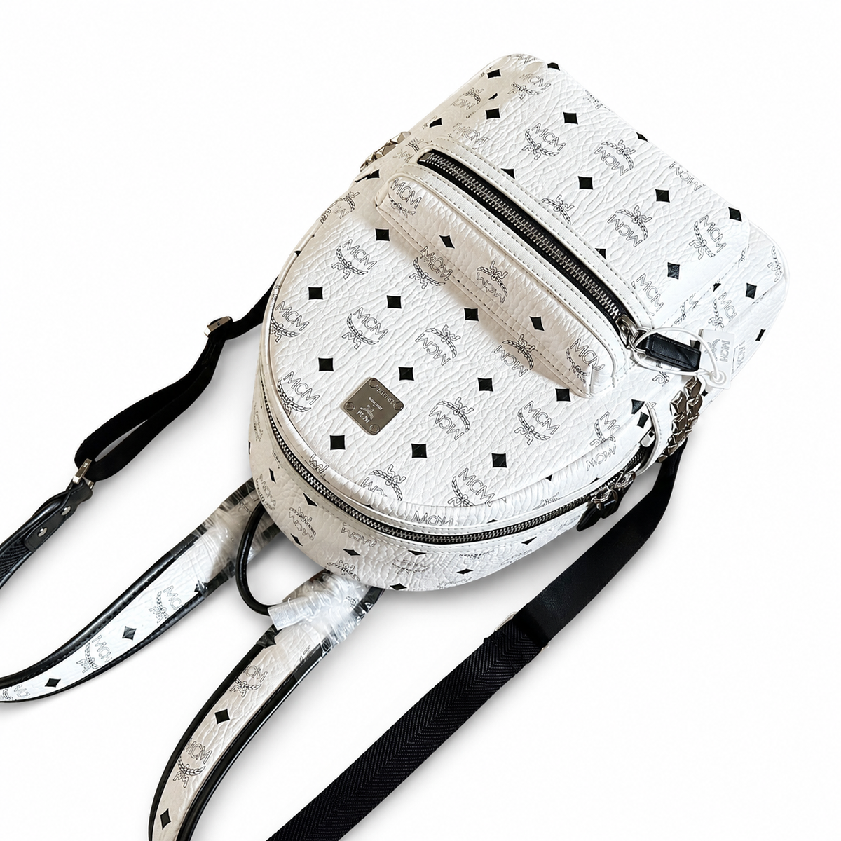 MCM all-over print + side rivets, unisex large-capacity commuter/travel bag.