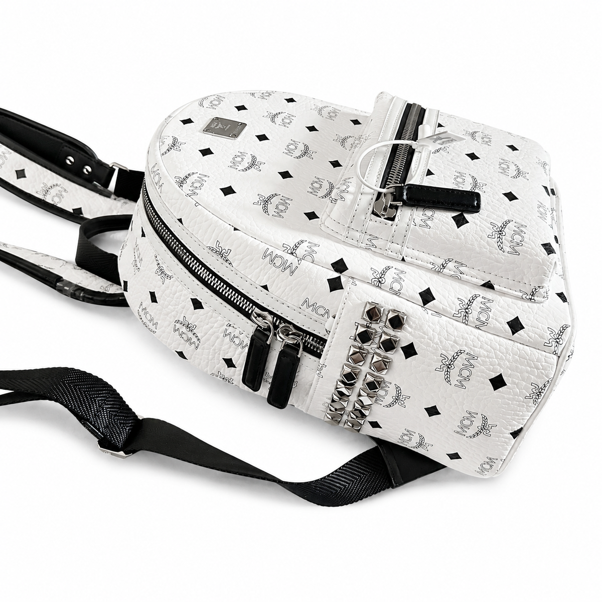 MCM all-over print + side rivets, unisex large-capacity commuter/travel bag.