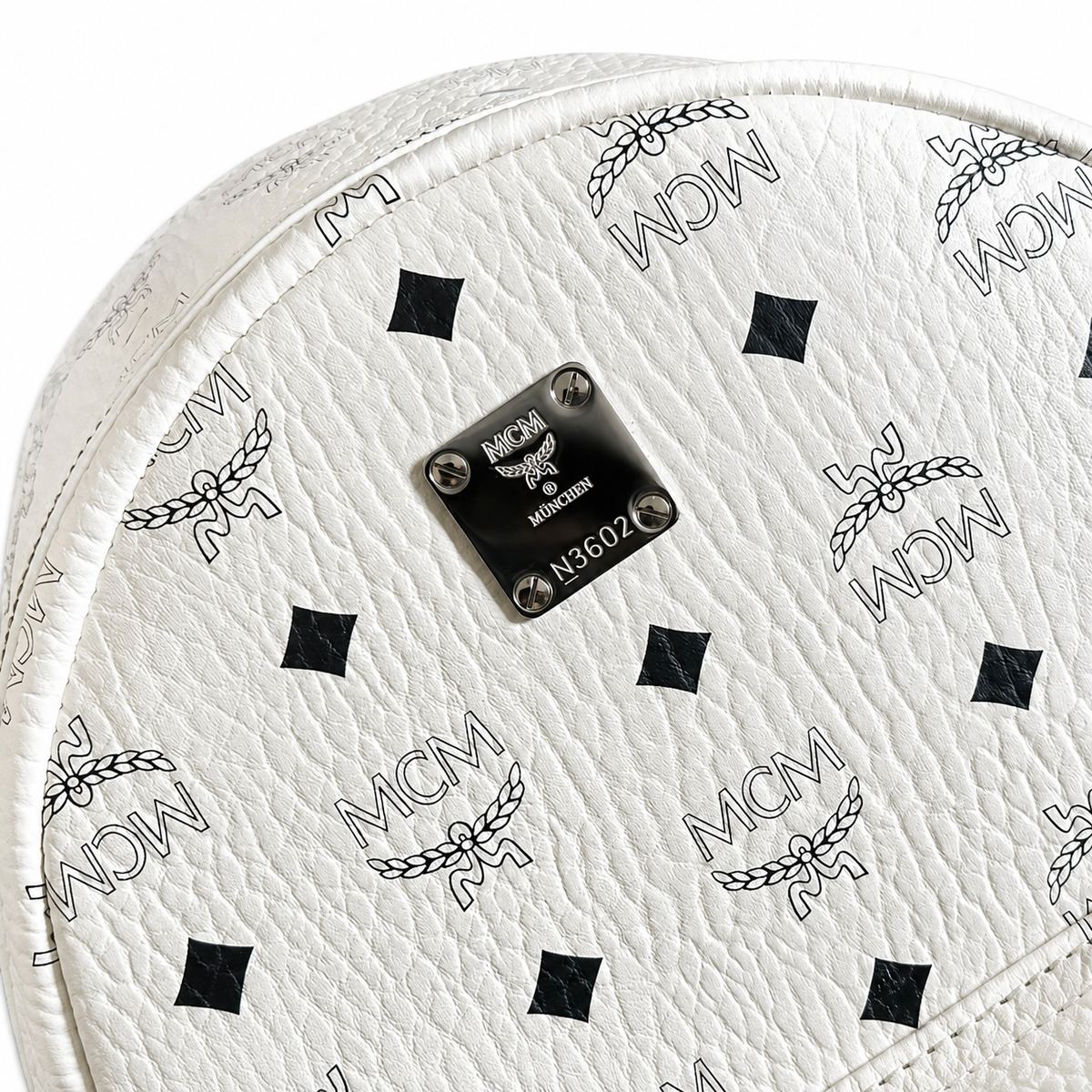 MCM all-over print + side rivets, unisex large-capacity commuter/travel bag.